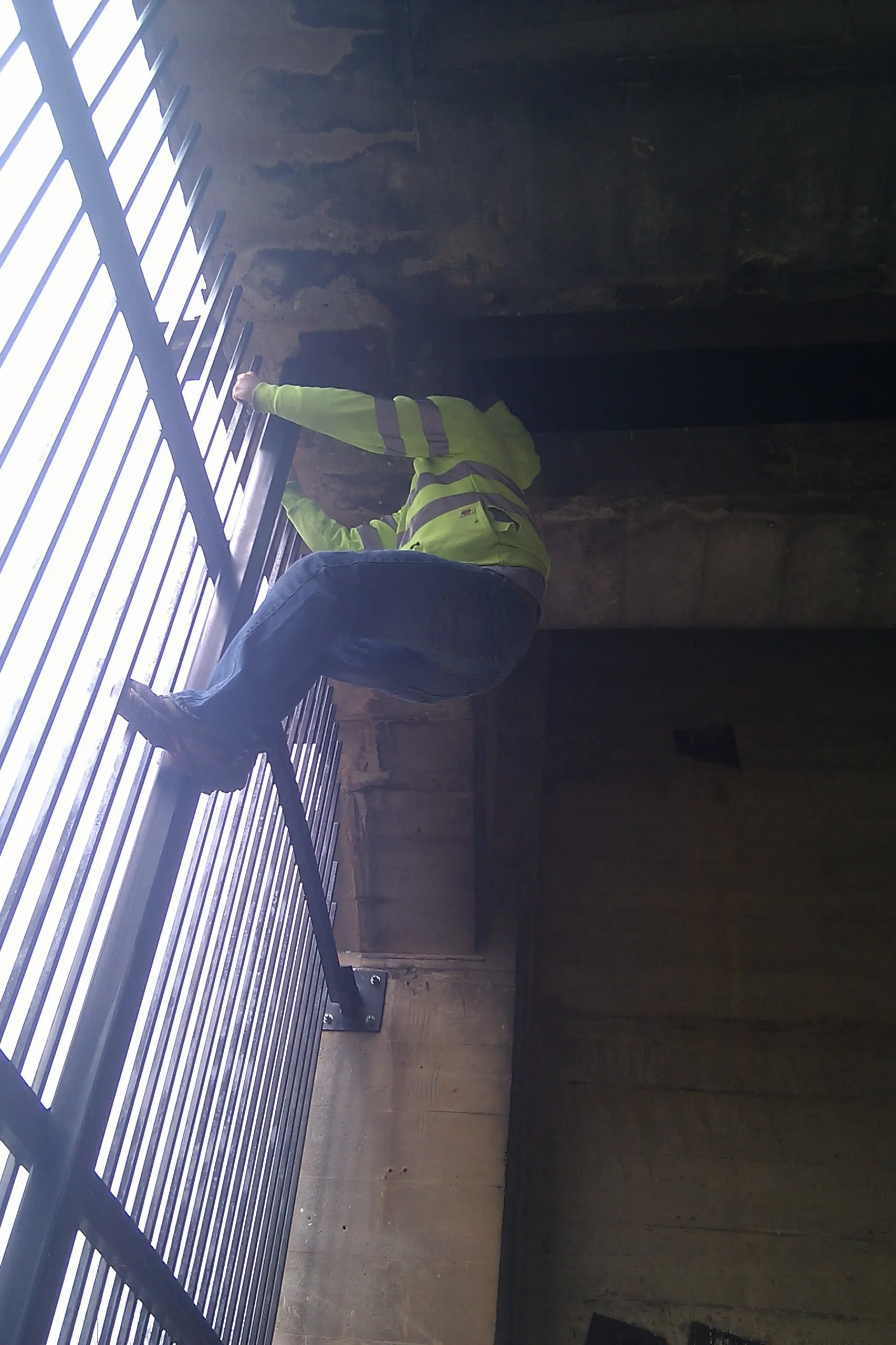 an electrical worker climbing some bars