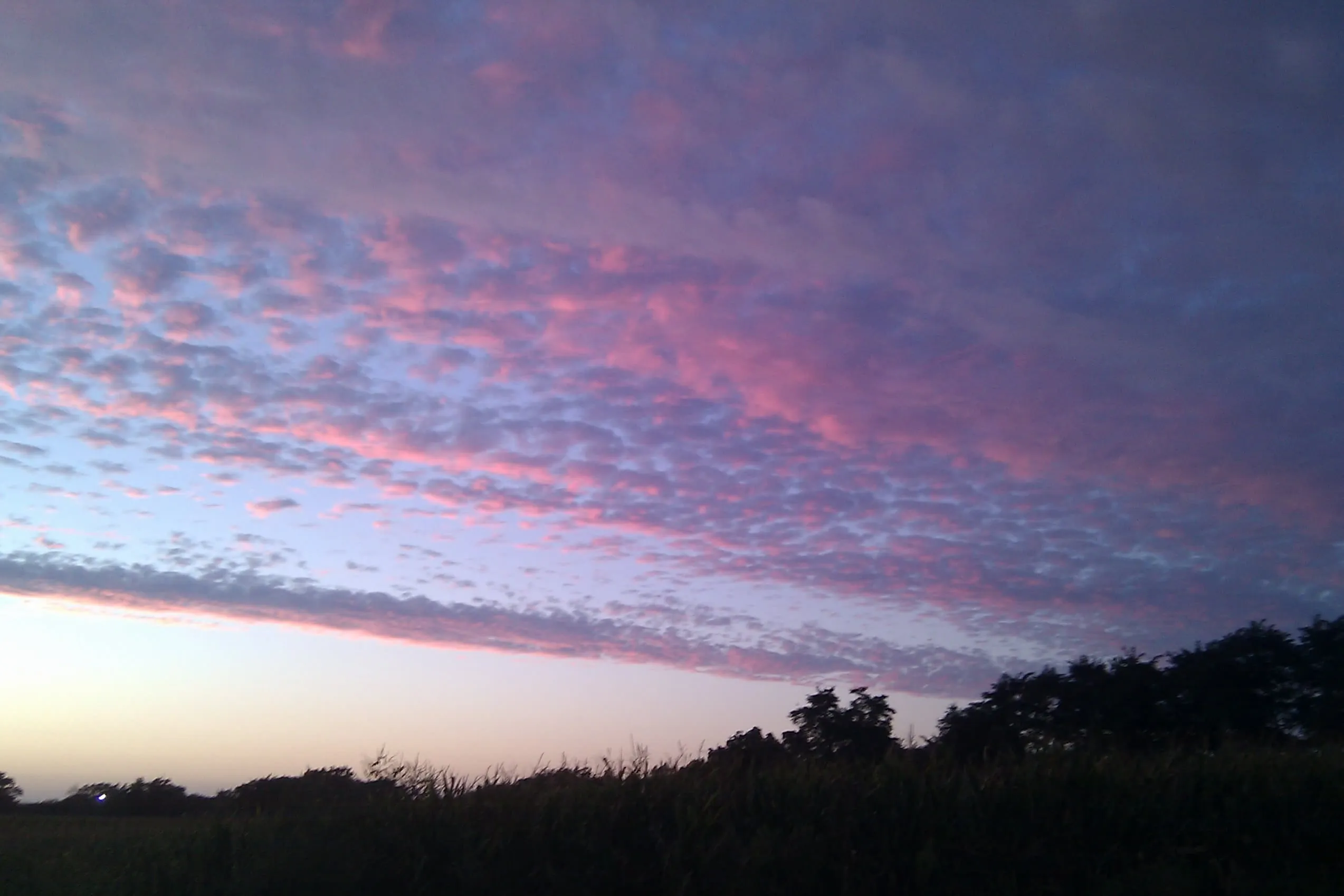 sky at dusk with parallel cloud patterns