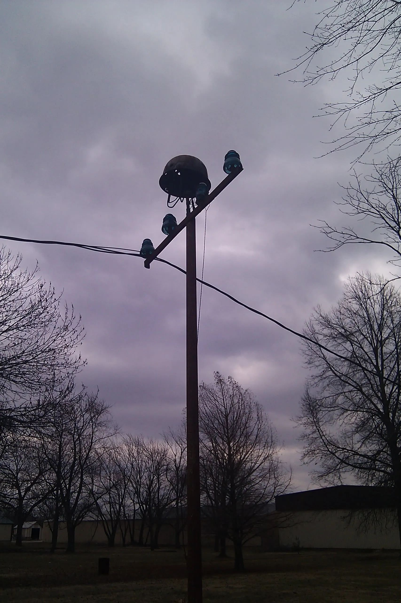 an odd telegraph pole that looks like a soldier's grave with a helmet