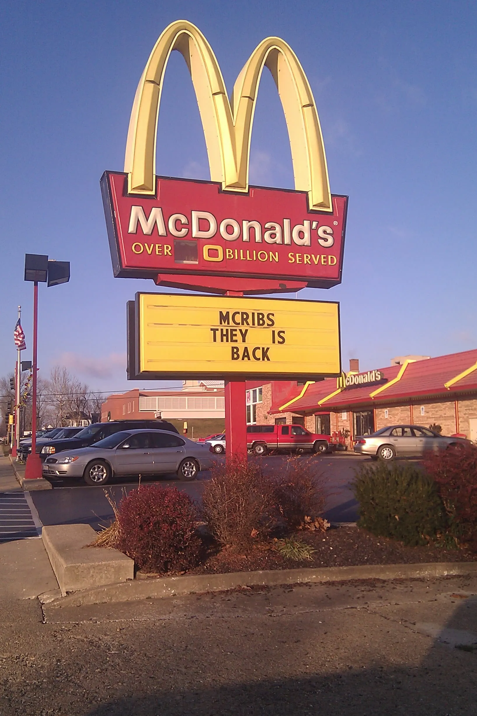 a broken McDonald's sign that says 'MCRIBS THEY IS BACK'