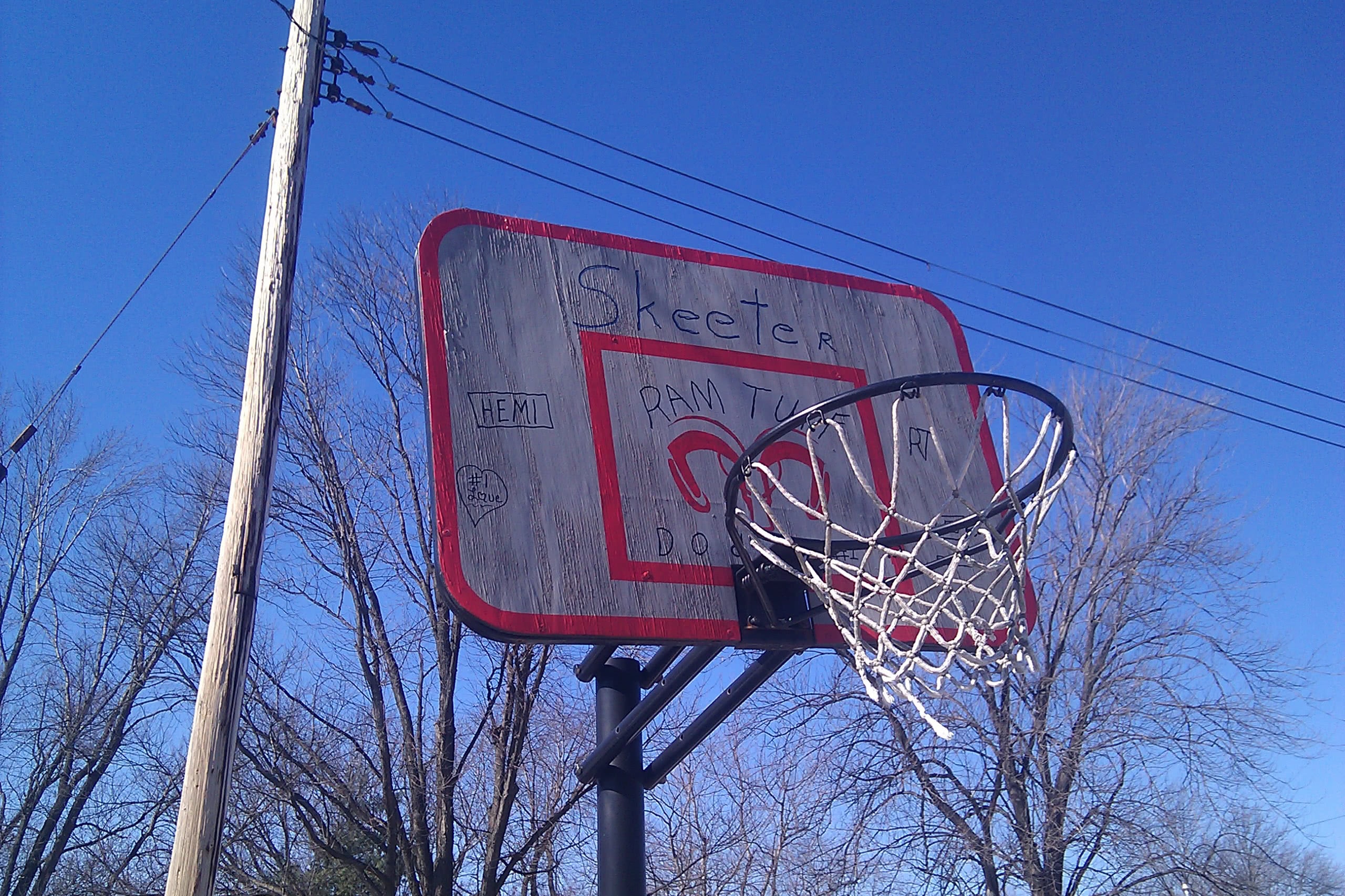 a homemade backboard with the Dodge Ram logo and the words hemi, skeeter, and ram tuff