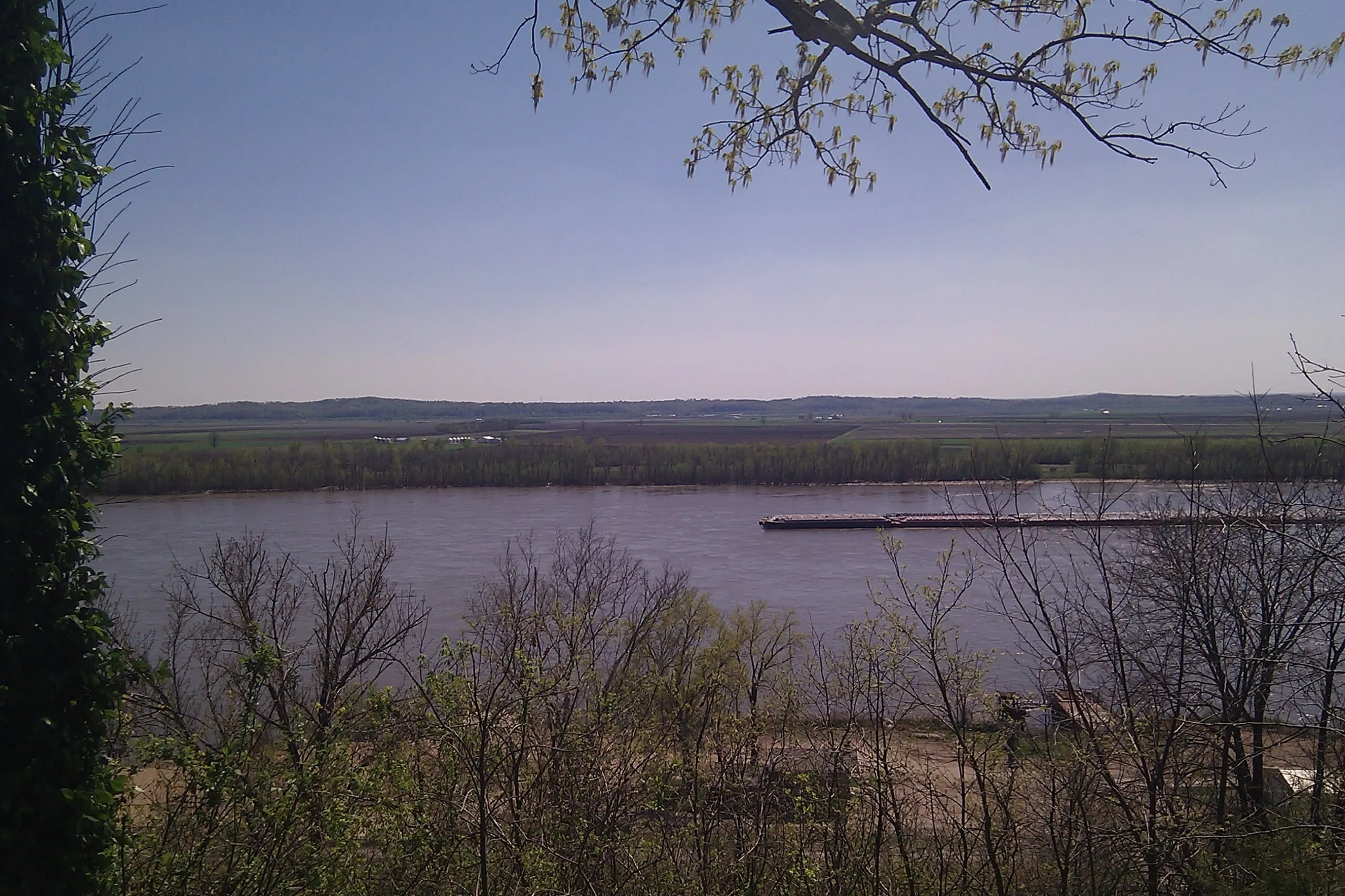 a barge floats down a river