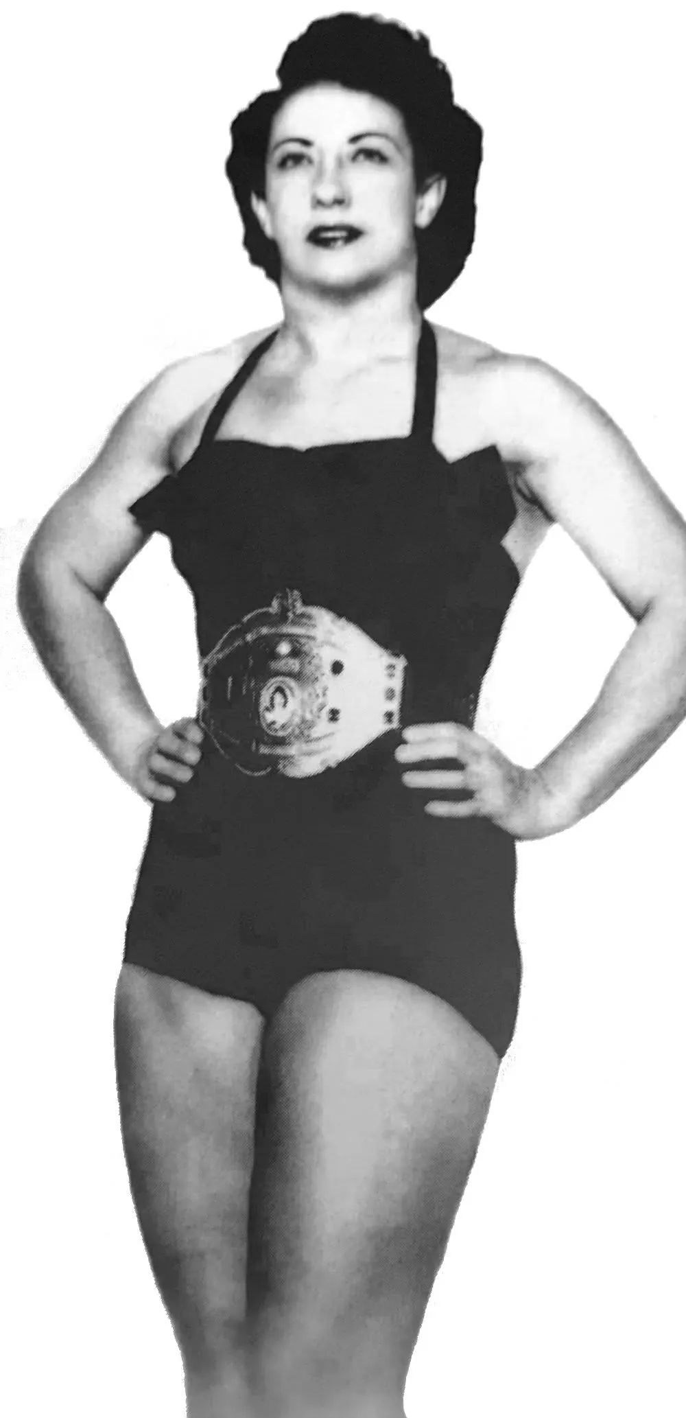 a promotional photo of a woman with black wrestling gear and a championship belt around her waist